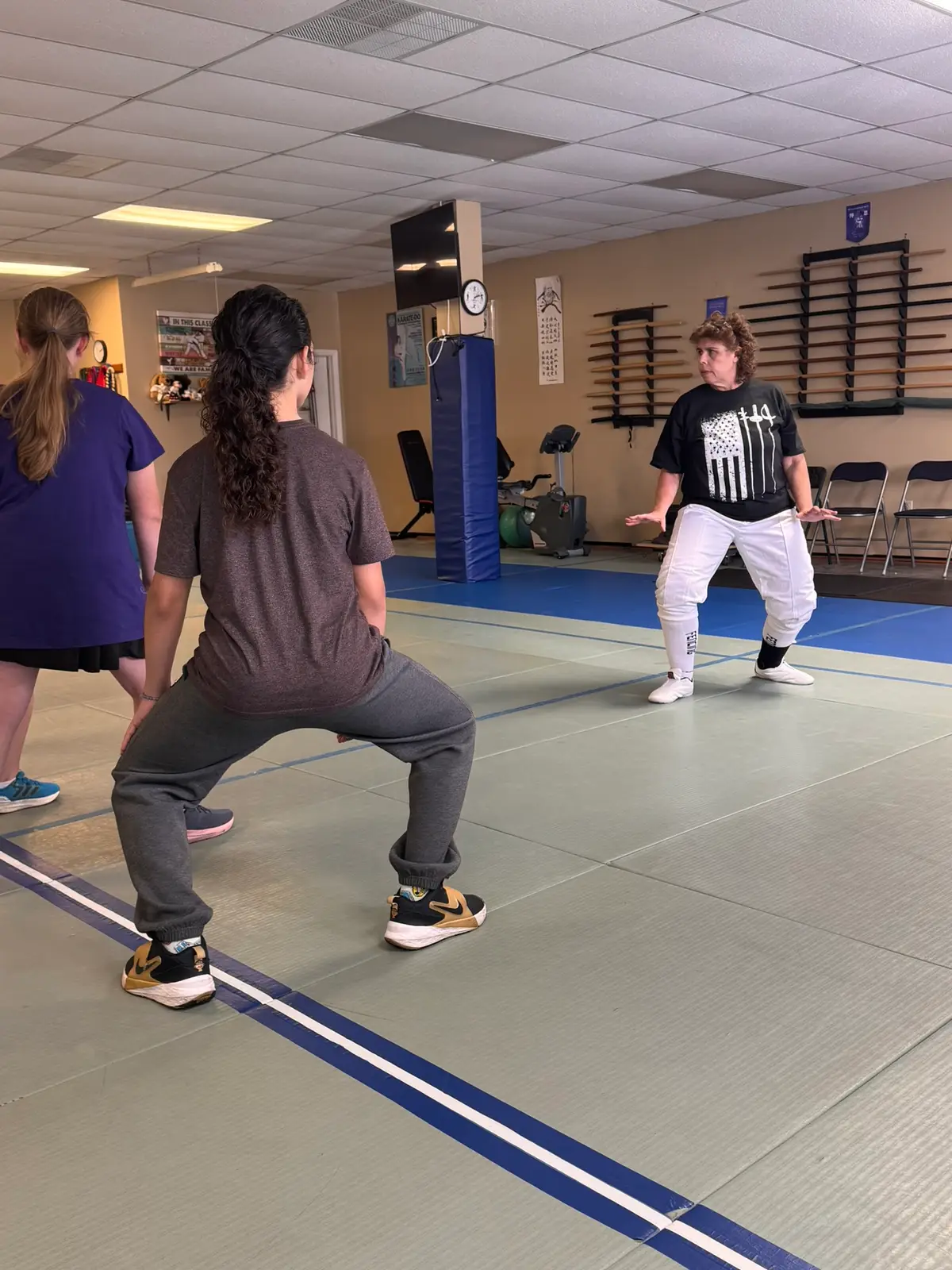 Fencer holding an en garde stance during class
