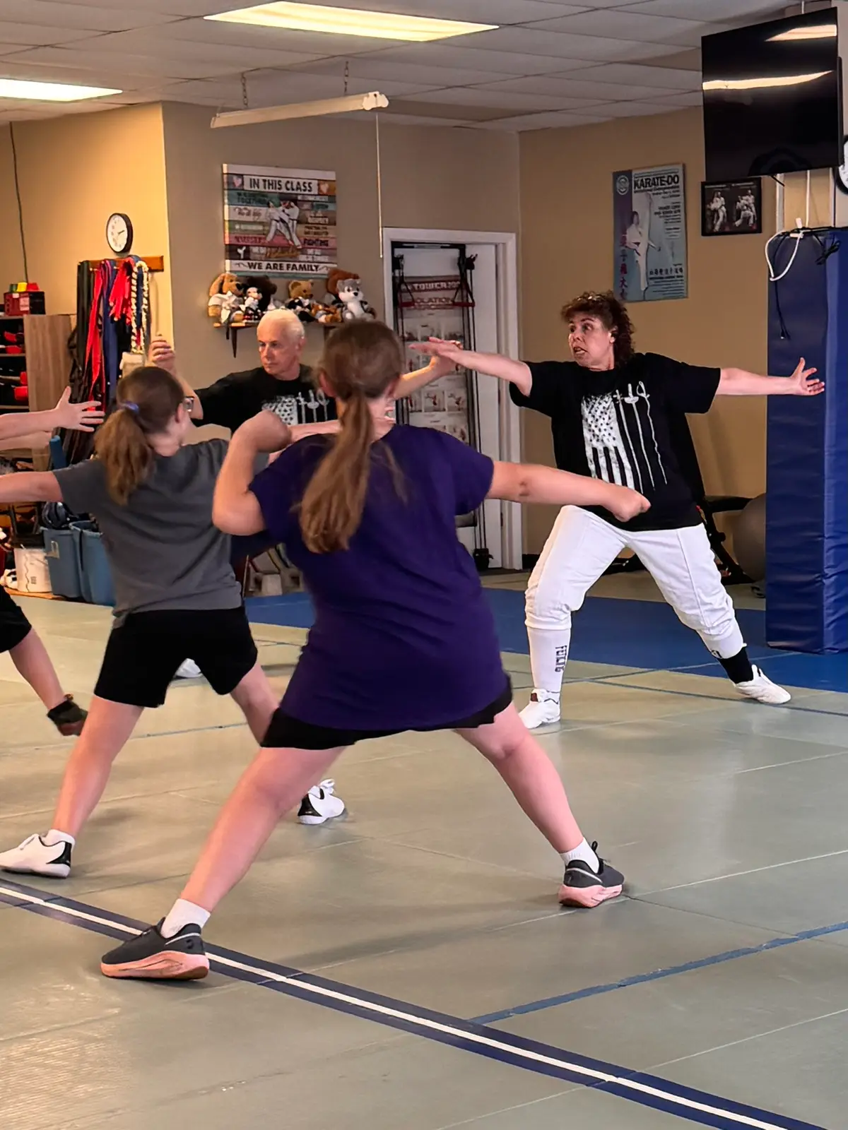 Two students lunging in a partner fencing drill