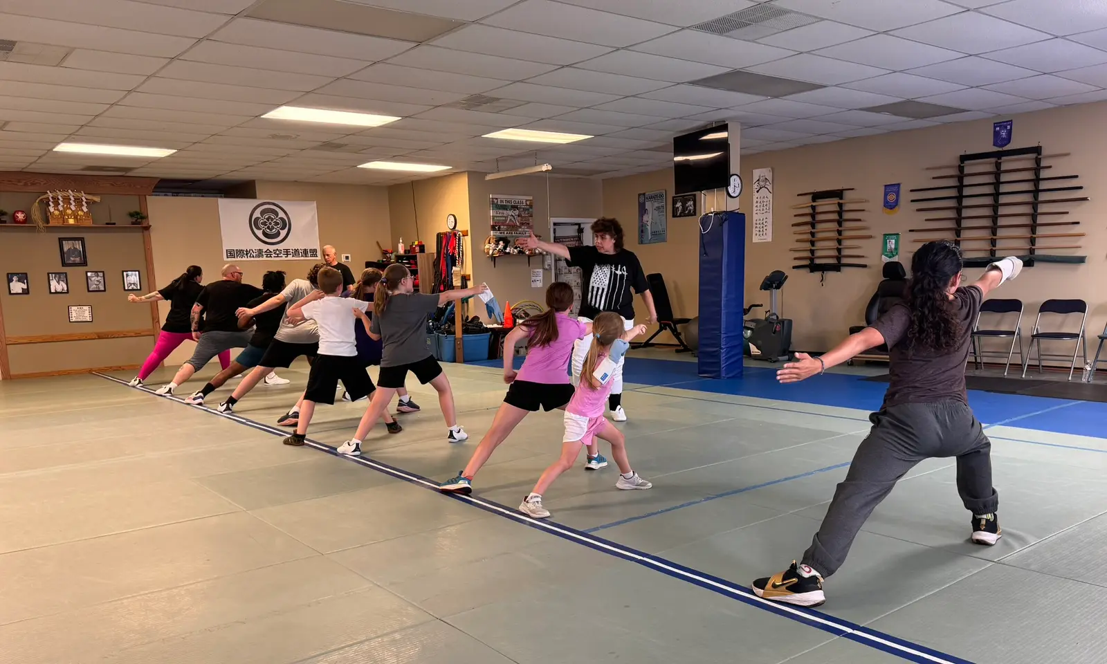 A line of students practicing the lunge in unison