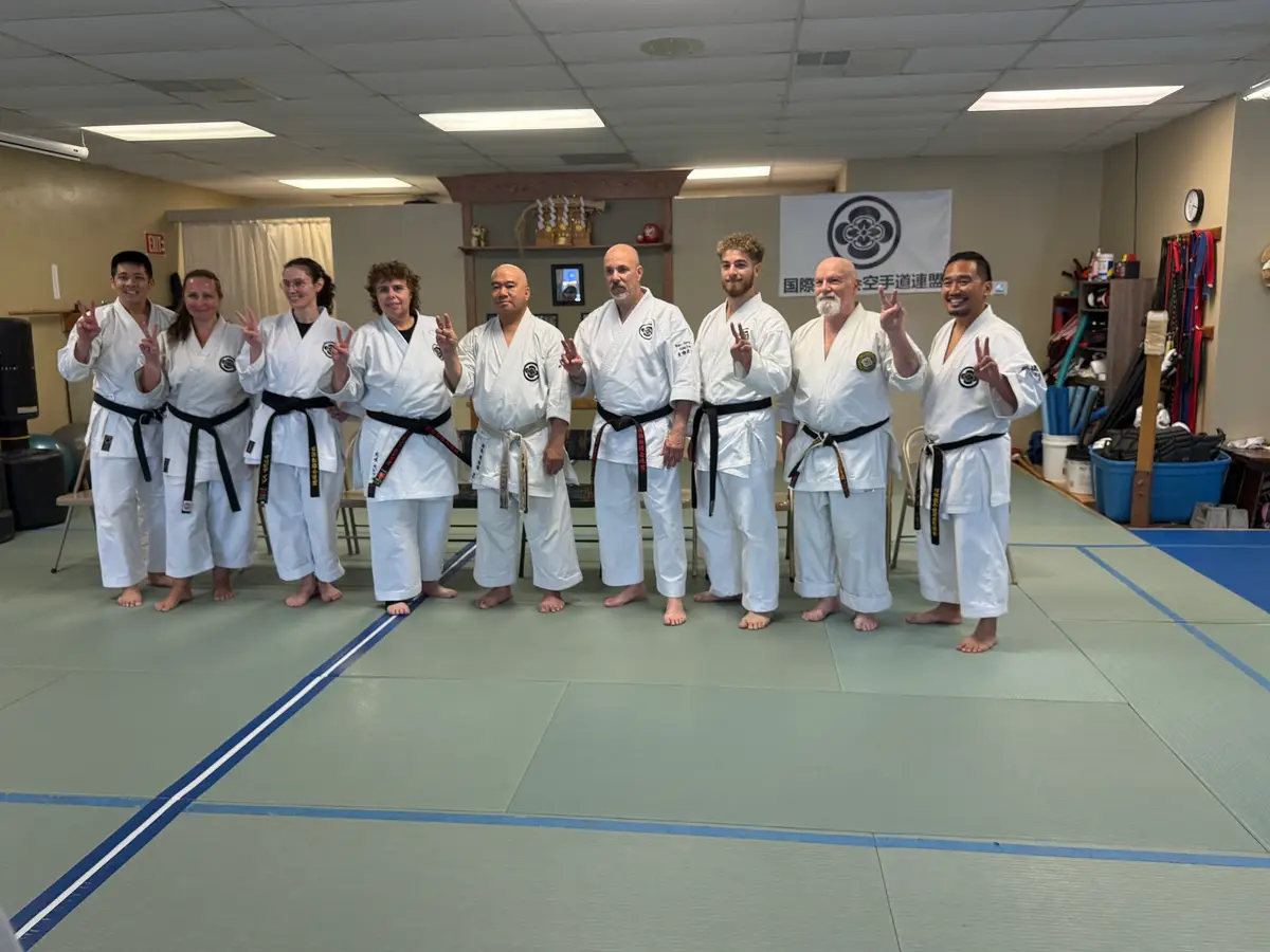 Adult karate students standing together on the dojo floor